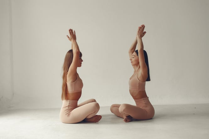 Two women in yoga poses.