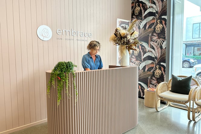 A female staff member working behind the counter at Embrace Skin and Beauty in Rolleston.
