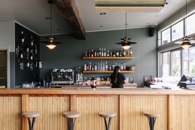 A staff member working behind the bar at Hāwea Store and Kitchen.