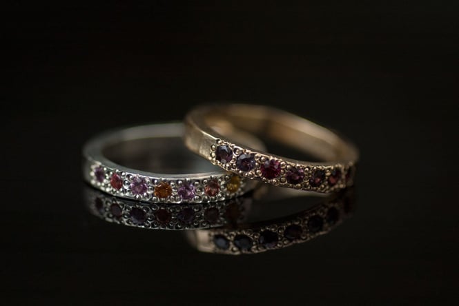 A close up of two jewelled rings stacked on top of each other.