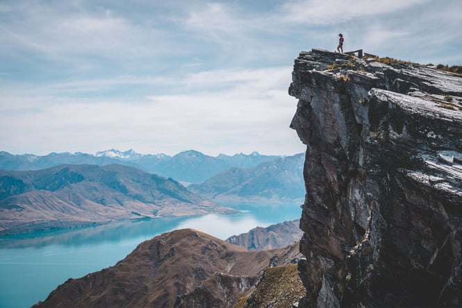 A person standing at the edge of a cliff.