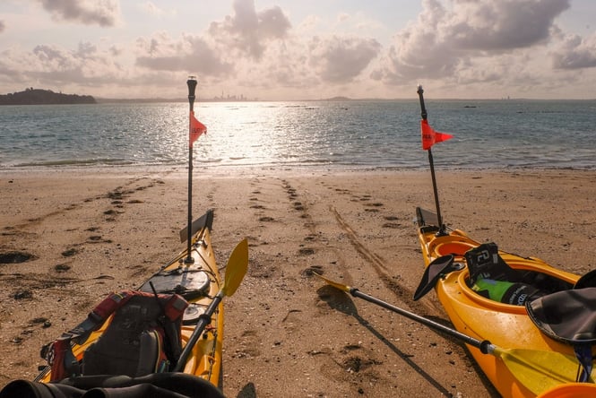 Two kayaks on a beach.