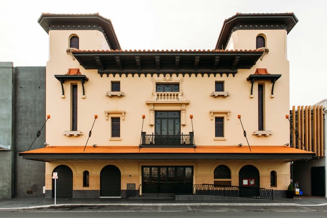 The orange and black exterior of the Hastings Municipal Building.