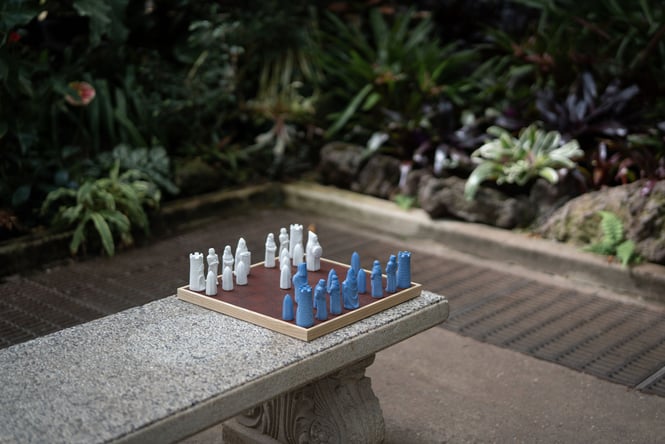 Blue and white chess pieces on a chess board.