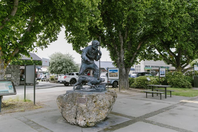 A sculpture of a man and his dog.