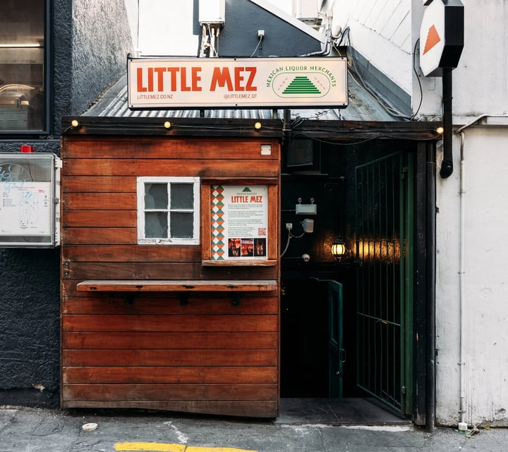 A little wooden hut entrance to Little Mez Queenstown.