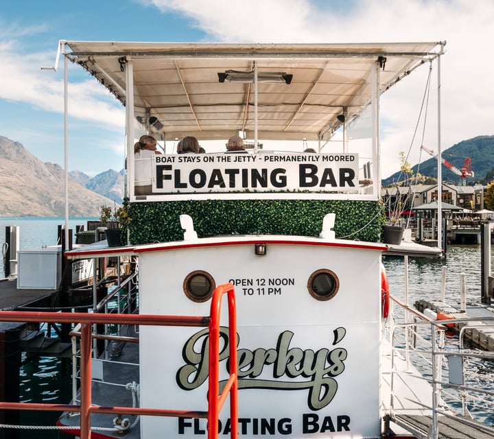 A 'floating bar' sign on a boat.