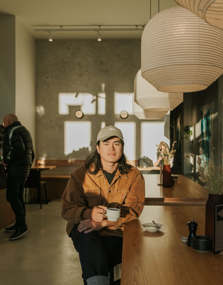 Christchurch cafe owner Sung Park drinking a coffee in the sun-drenched space of Akin