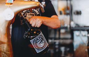 A bottle being filled up with craft beer at The Brewery Christchurch.