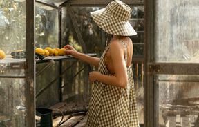 Woman wearing gingham hat and dress from Mina.