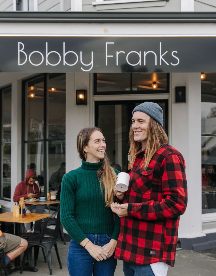 Kiera and Marc Shaw of Bobby Franks smiling at each other outside their Nelson cafe.