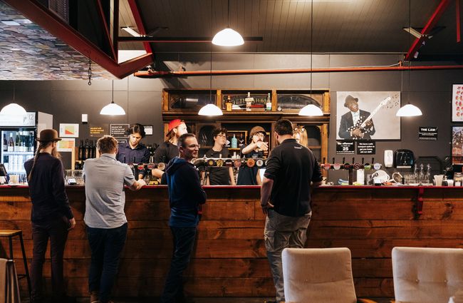 A group of customers ordering at the bar at 12 Bar in Christchurch.