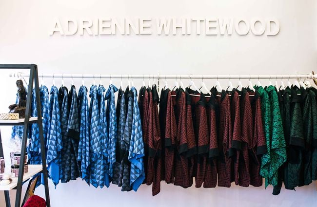 Adrienne Whitewood clothes on display on a rack.