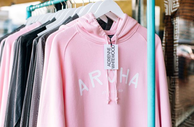 Close up of a pink hoodie on a rack.