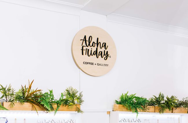 Wooden sign with Aloha Friday logo in Porirua.