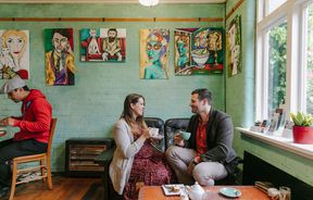 Couple sat at a table drinking coffee at Arthur St Kitchen, South Canterbury.