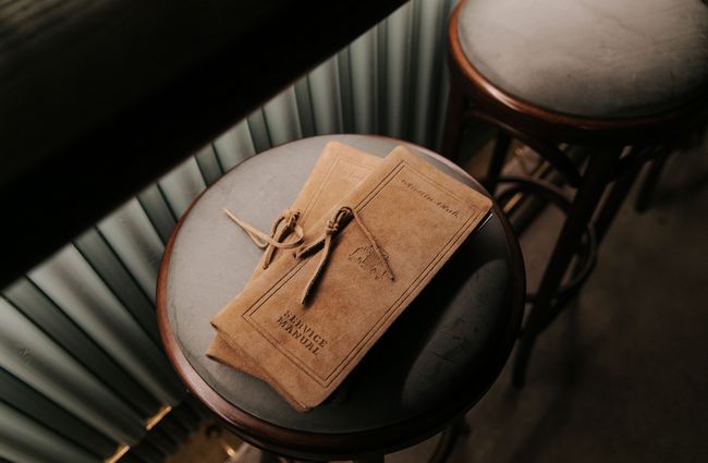 Leather-covered drinks menu on a stool at Austin Club in Christchurch.