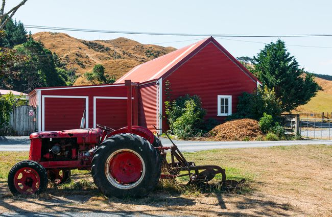 Red tractor and red shearing shed.