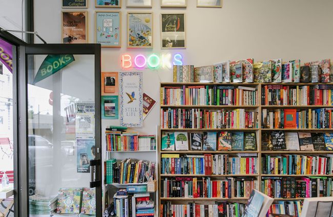 Entrance to Bay Hill Booksellers with neon sign on the wall at Bay Hills Books in Timaru, New Zealand.