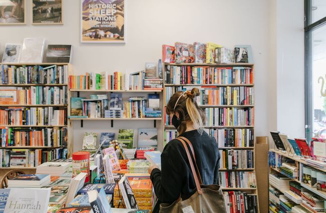 Woman browsing books at Bay Hills Books in Timaru, New Zealand.
