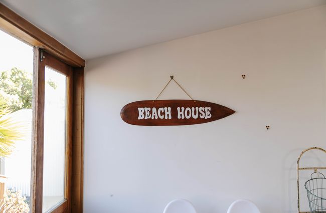 Beach House sign hanging on the wall.
