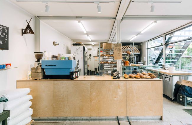Interior view of the coffee counter and working bakery behind at Billow, New Plymouth.