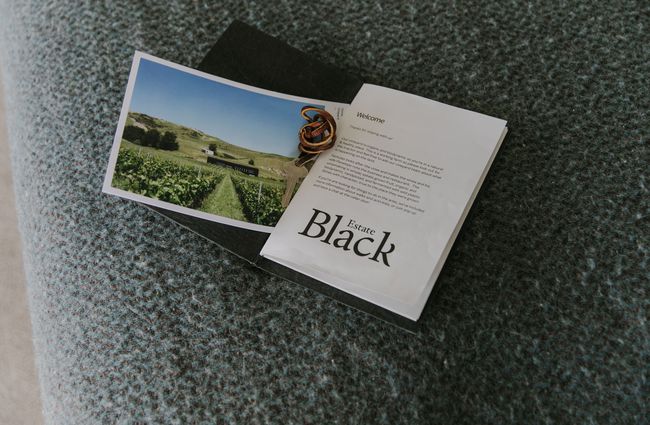 Welcome pack and key to Black Estate Accommodation.