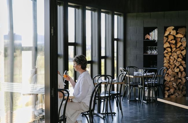 Woman about to drink glass of wine at Black Estate, North Canterbury.