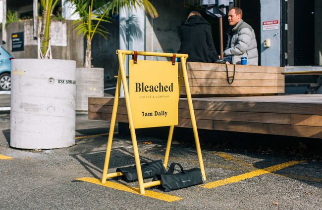 A yellow outdoor sign saying 'Bleached'.