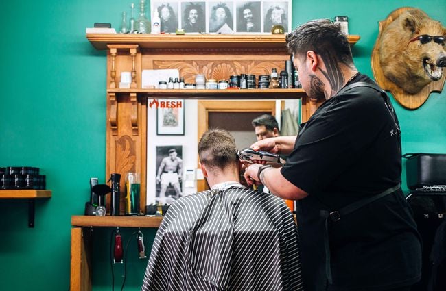 Barber giving man a hair cut.