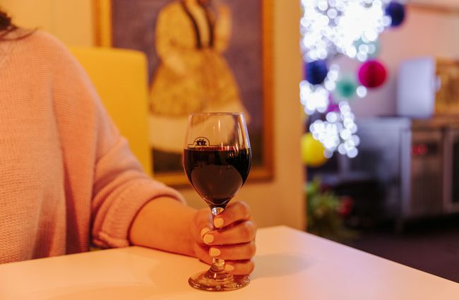 Woman holding a glass of red wine.