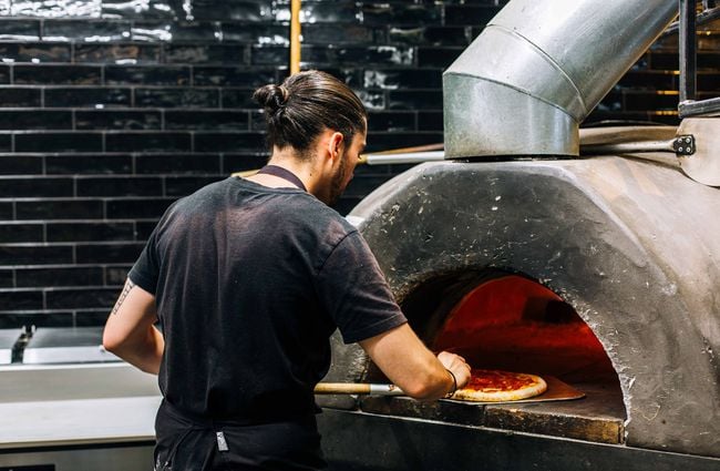 A man making pizza.