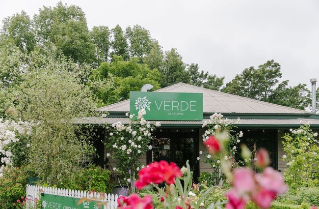 The entrance to Cafe Verde obstructed by lots of green bushes in Geraldine.
