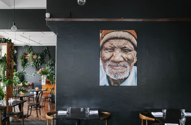 Picture of a man hanging on the wall at Cucina in Ōamaru.