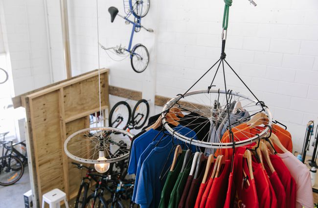 T-shirts hanging off old bike wheel at Cycle Ventures in Waitaki.