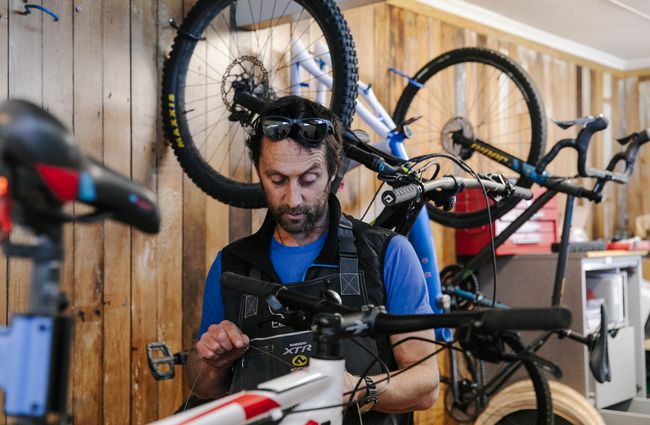 Man fixing a bike at Cycle Ventures in Waitaki.