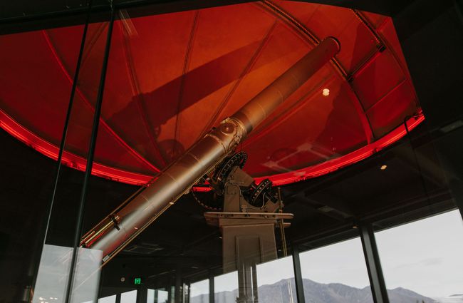 Telescope under red light at Dark Sky Diner, Tekapo.