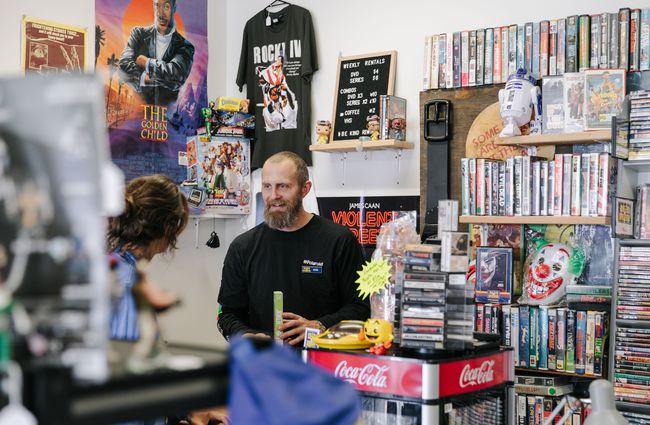 Evan chatting to a customer at Dead Video in Lyttelton.