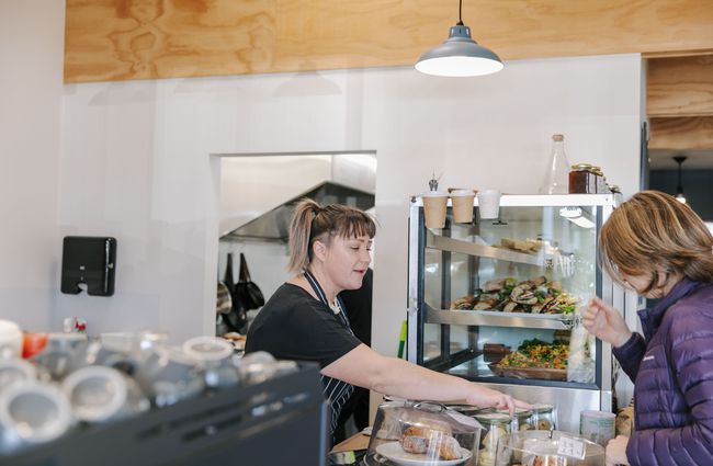 Woman serving a customer at Dispense Espresso in Christchurch.