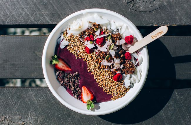 Colourful acai bowl on a wooden table.