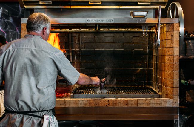 Chef cooking on the grill at Ember, New Plymouth.