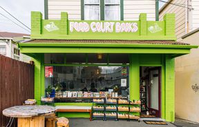 The bright green building that is Food Court Books in Newtown's Wellington.
