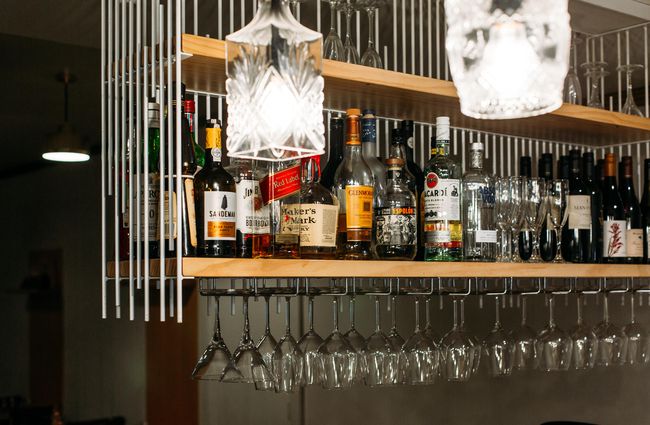 Drinks and spirits on a shelf above the bar at Fork N Knife, New Plymouth.