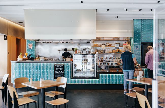 Bright turquoise counter and chef station at Foundation Café in Christchurch.