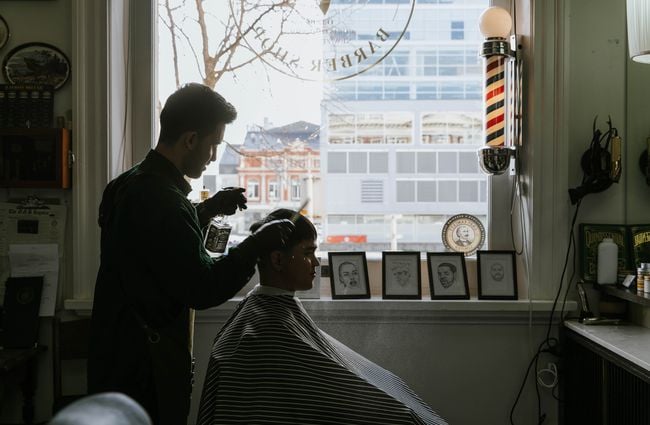 A barber at work at Frederick Woodward's Barber Shop in Christchurch.