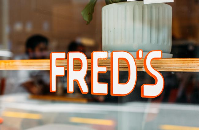 Exterior window sign for Fred's, Wellington.