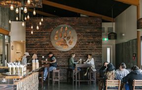 Dining area with customers drinking and eating at Golden Bear Brewing Company, Māpua Tasman.