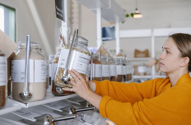 Woman putting jar back on the shelf at GoodFor in Christchurch.
