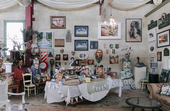 Table of artworks and curios at Grainstore Gallery in Ōamaru.