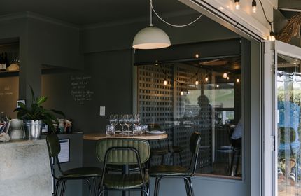 Dining table with green leather chairs at Greystone Wines, North Canterbury.